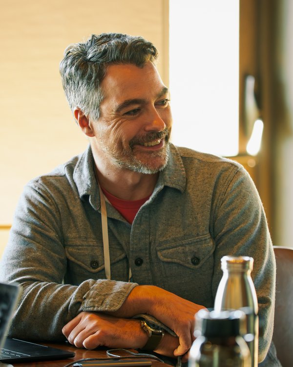 Jason Weeby, smiling, working at a table
